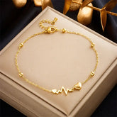 Gold-toned heart and heartbeat anklet.