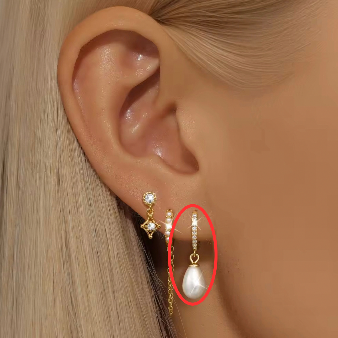 Person Wearing Bella Pearl Huggie Earrings