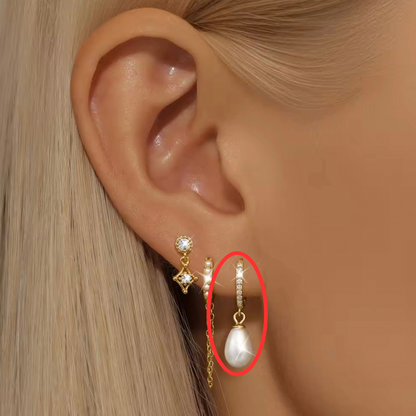 Person Wearing Bella Pearl Huggie Earrings