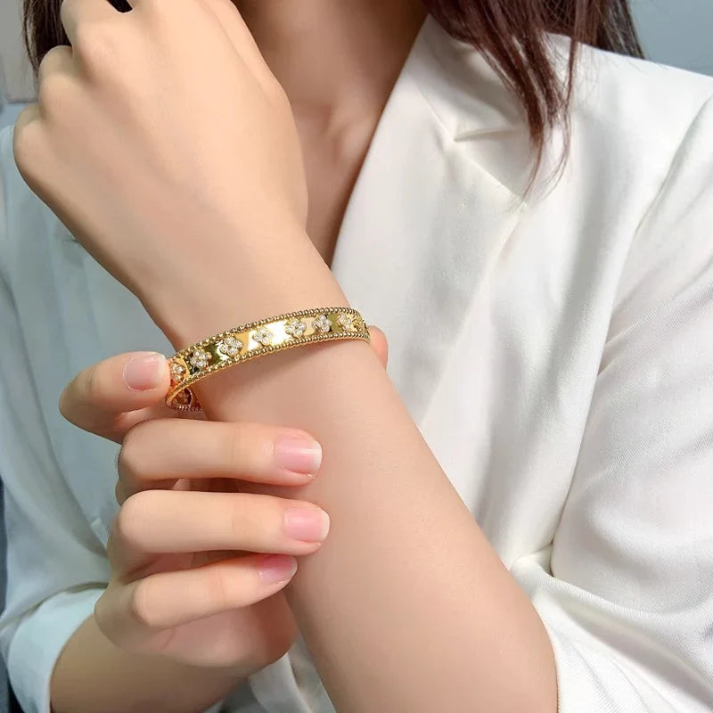 Gold bracelet on a wrist with a blurred background