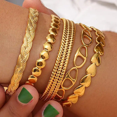 Gold-toned bracelet stack.
